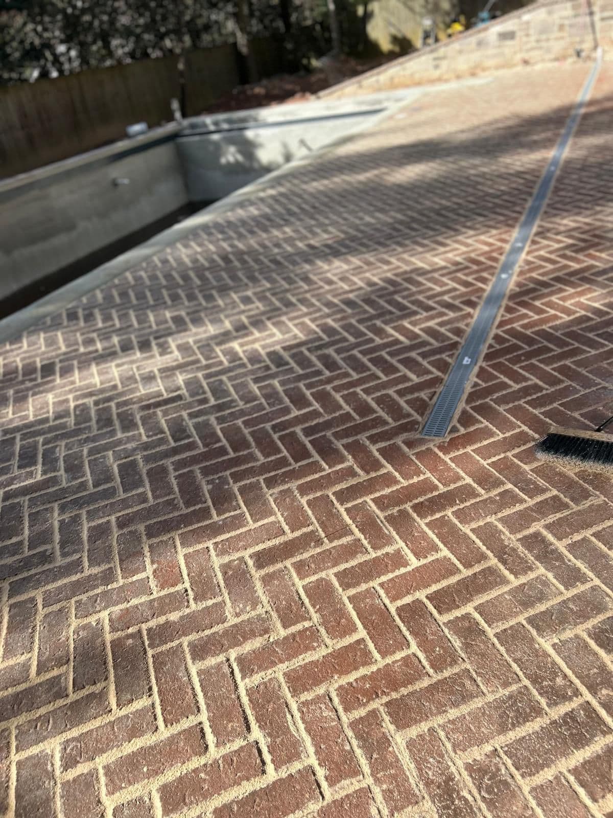 Brick pool deck with linear drain detail