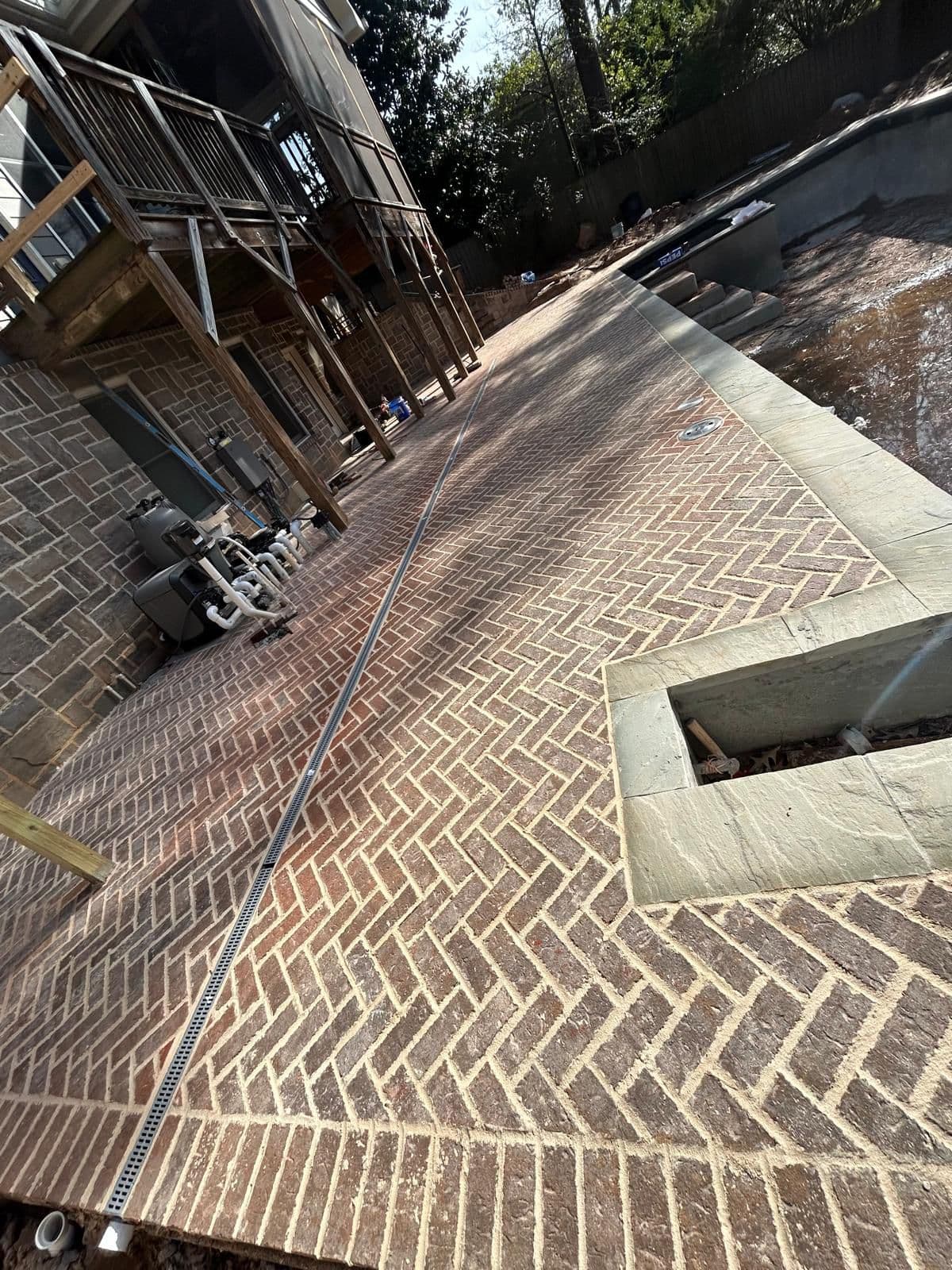 Brick pool deck with spa and patio area